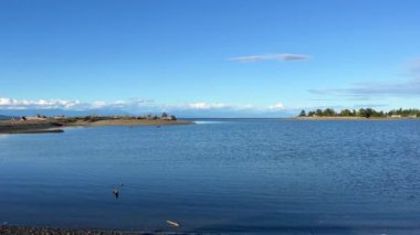 complete calm no wind no waves on pacific ocean looks like a lake on Vancouver island blue water silence calm tranquility and peace great place to relax background Parksville beach Surfside RV resort