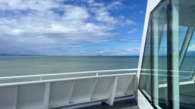 the view from the deck of the covering ship to the sea or ocean is visible Horizon clear blue color of water and sky can be used as a background For title text or advertising calm rest and relaxation