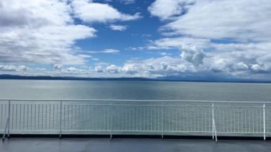 the view from the deck of the covering ship to the sea or ocean is visible Horizon clear blue color of water and sky can be used as a background For title text or advertising calm rest and relaxation