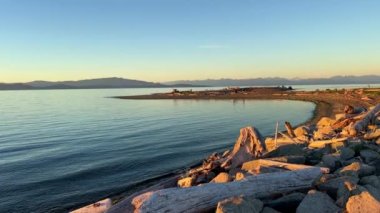 sunset on Ocean Horizon mountains are far visible clouds and bright colors slow motion video suitable for music background For text silence peace Parksville beach Surfside RV resort 08.2022 Canada