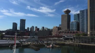 Canada Place View of the city from the Pacific Ocean high buildings glass skyscrapers are visible Clear skies good weather in Vancouver city Canada. High quality 4k footage