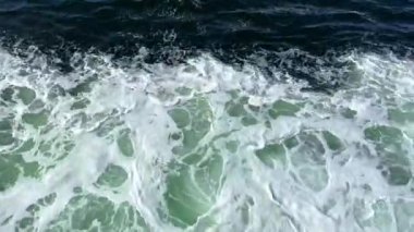 white streaks on the emerald green water of a river or ocean is perfect For text for the beginning of an advertising film, life is seething empty space For text room decoration picture. High quality