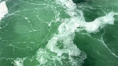 white streaks on the emerald green water of a river or ocean is perfect For text for the beginning of an advertising film, life is seething empty space For text room decoration picture. High quality