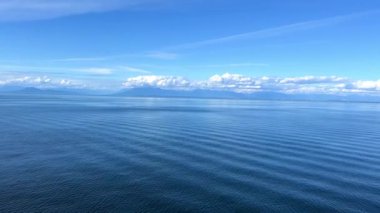 a journey across the Pacific Ocean on a liner, only the sea and water and the sky are visible, everything is blue, the horizon and a small part of the ship, rest on the water. High quality 4k footage