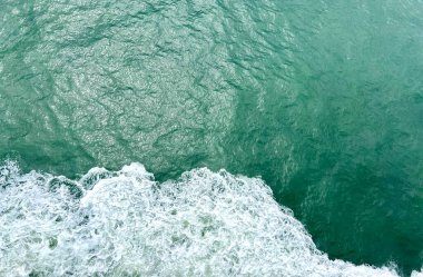 Emerald water seethes very beautiful background for any text for any video for advertising and announcement rates a seething ocean small strips of white foam on it deep and green Canada