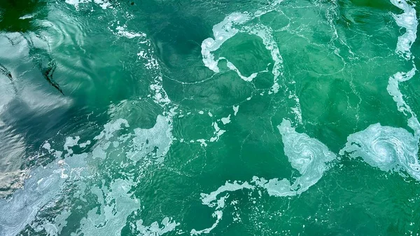 Emerald water seethes very beautiful background for any text for any video for advertising and announcement rates a seething ocean small strips of white foam on it deep and green Canada