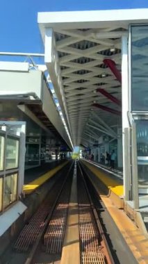 Train is traveling on road towards another skytrain coming from the front window this is driverless subway train is coming from Surrey Slow motion video is visible All around. canada Vancouver 07.2022