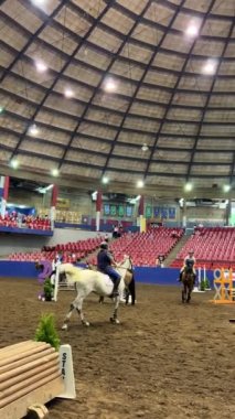 Horses on the Great Circus Field hippodrome Presentation of horses people galloping on horses I pass is a slow step everywhere people sit on seats High dome overhead Canada Vancouver 31.08.2022