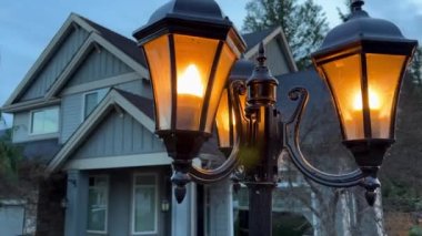 The evening is lit by a lantern near the house, it is just starting to get dark, a private house is located in Canada British Columbia Surrey 09.2022. High quality 4k footage