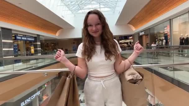 Una Joven Adolescente Salta Alegría Mientras Baila Sosteniendo Paquetes Con — Vídeos de Stock