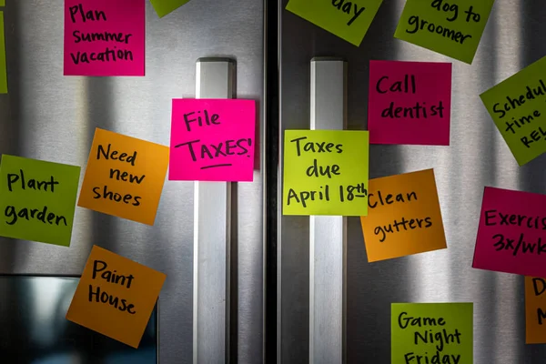 Refrigerator Door Colorful Memo Notes Reminding File Taxes April Eighteenth — ストック写真