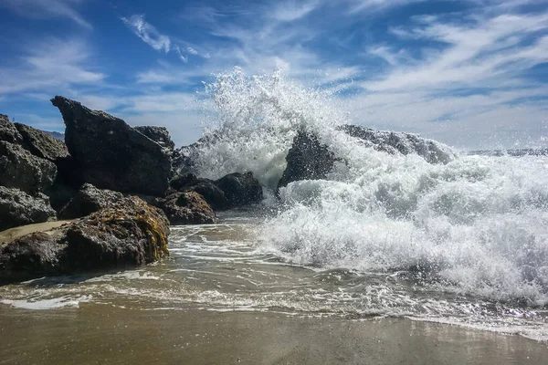 stock image Waves crashing on rocks on coast