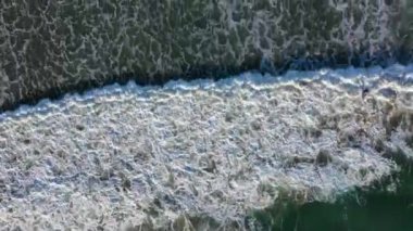 Drone Aerial Above the Pacific Ocean at the Beach Above Waves Following Waves Onto Shoreline Coast