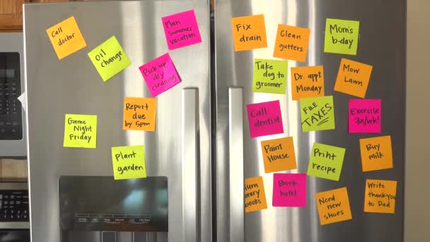 Refrigerator Door Filled Reminder Notes Hand Adds Taxes Due April — Stockvideo