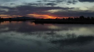Drone Aerial Flying Quickly Left Over Lake Surface at Sunset