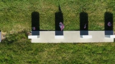 Drone Aerial Looking Directly Down and Ascending from Headstone With American Flag to Field of Headstones