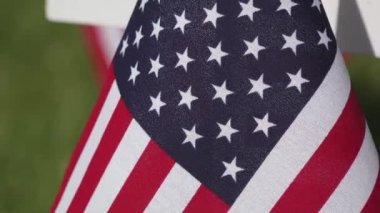 Zoom Out from American Flag and Cemetery Cross