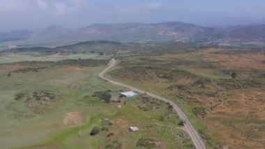 aerial Open green field surrounding highway