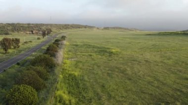 aerial Open green field surrounding highway