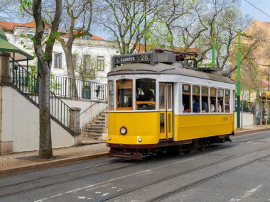 Lisboa, Portugal. April 9, 2022: Yellow tram on the streets of the city.