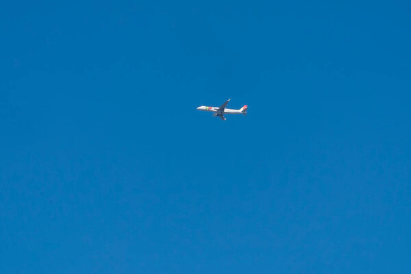 Airplane in the air with blue sky. Lisboa, Portugal. 
