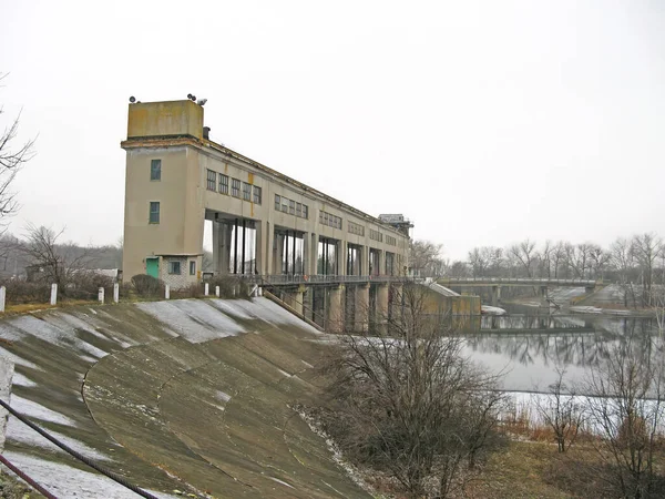 view of the hydroelectric dam, water discharge through locks, long exposure shooting. Hydropower dam in Ukraine. A dam on a winter river. Dam to release water on the river.