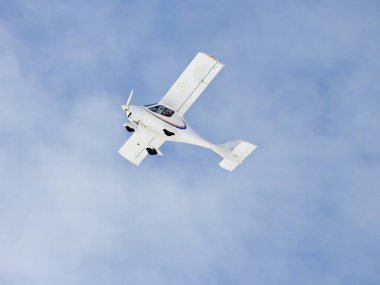 Zoom photo of small propeller airplane landing to small airport.