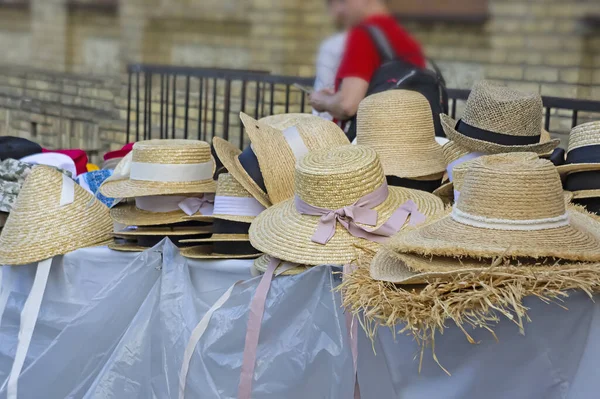 market stall with straw hats. Big group of authentic panama hats or paja toquilla hats made from straw at craft market