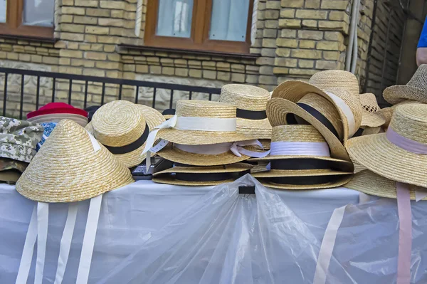 market stall with straw hats. Big group of authentic panama hats or paja toquilla hats made from straw at craft market