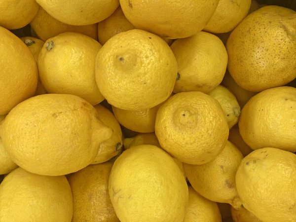 Ripe Yellow Lemons Close-up Background Or Texture. Lemon Harvest Many Yellow Lemons.
