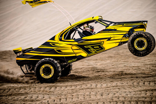 Doha, Qatar- February 23, 2018: Off road buggy car in the sand dunes of the Qatari desert.