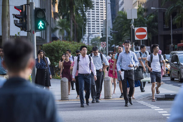 Singapore City, Singapore - September 08, 2019: At the end of the working dayoffice workers walking on the streets of the Central Business District.