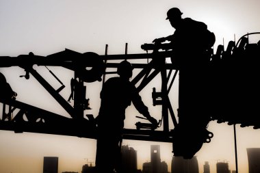 Doha, Katar - 11 Aralık 2017. İnşaat işçileri Doha 'daki arka plandaki gökdelenlerde çalışmak için vinç hazırlıyorlar..