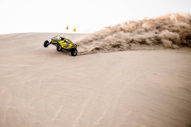 Doha, Qatar- February 23, 2018: Off road buggy car in the sand dunes of the Qatari desert. clipart