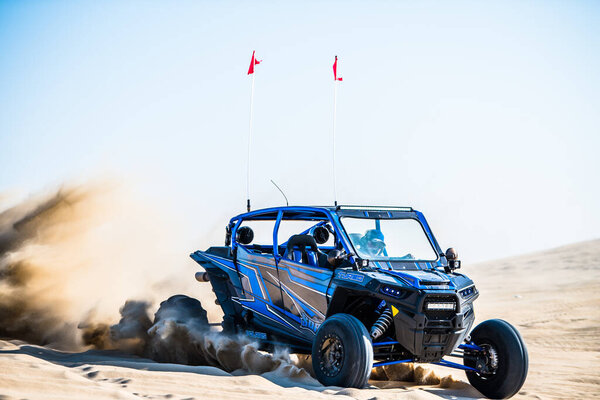 Doha, Qatar- February 23, 2018: Off road buggy car in the sand dunes of the Qatari desert.