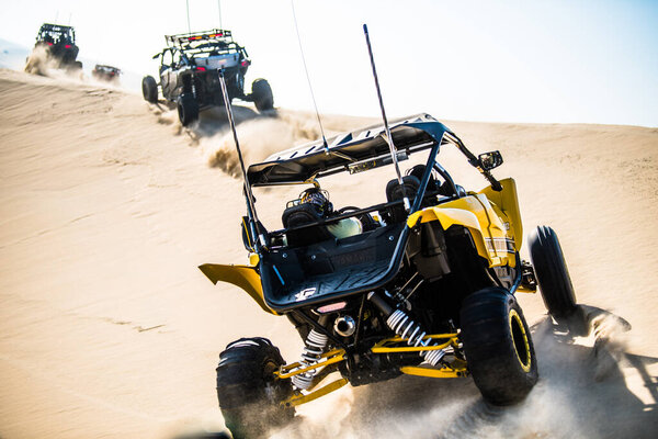 Doha, Qatar- February 23, 2018: Off road buggy car in the sand dunes of the Qatari desert.