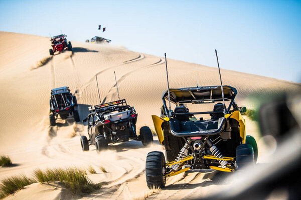 Doha, Qatar- February 23, 2018: Off road buggy car in the sand dunes of the Qatari desert.