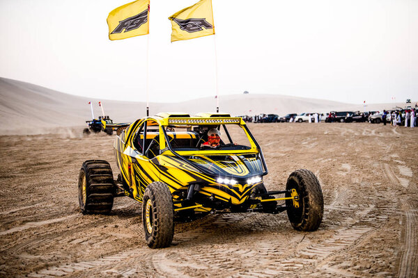Doha, Qatar- April 23, 2022: Off road buggy car in the sand dunes of the Qatari desert.
