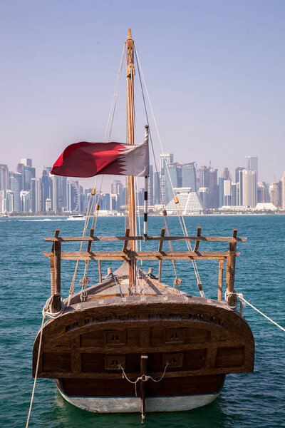 Doha,Qatar- April 24,2022 :  Traditional dhow boats with the futuristic skyline of Doha in the background.