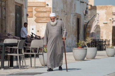 Doha ,Qatar - February 01,2020 : New souk Al Wakrah waterfront promenade with his traditional housesand local people enjoying walking.