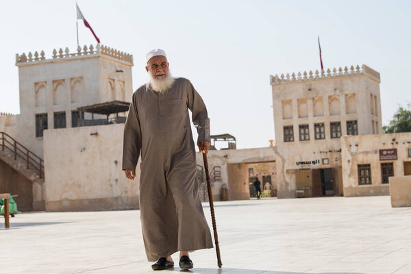 Doha ,Qatar - February 01,2020 : New souk Al Wakrah waterfront promenade with his traditional housesand local people enjoying walking.