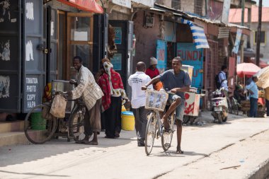 Zanzibar City, Tanzania - May 01,2022: Street view of the usual daily life of local people all ages taking place along the road on the Zanzibar Island in Tanzania.