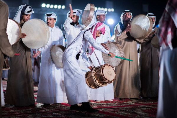 Doha, Qatar, December 18,2017: The drummers dressed in traditional clothes as part of a performance called the "ardha" sword dance at the Darb Al Saai, organized to celebrate Qatar National Day.