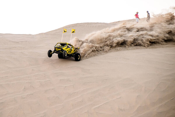 Doha, Qatar- April 23, 2022: Off road buggy car in the sand dunes of the Qatari desert.