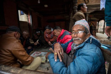 Katmandu, Nepal - 20 Nisan 2022: Geleneksel masa oyunları oynayarak Patan Durbar Meydanı sakinleri.