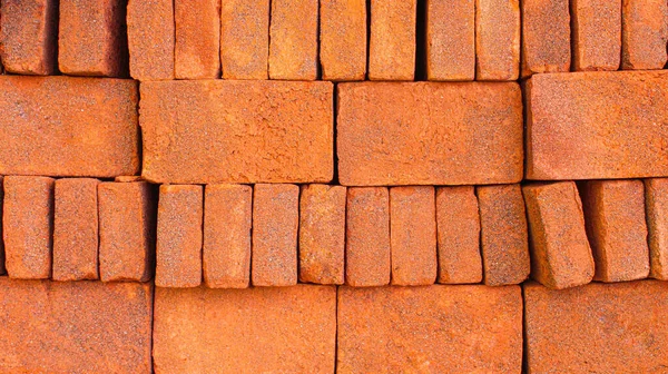 Stacks of beautiful red bricks in different layouts to form a pattern, Arrangement of solid clay bricks used for construction, red brick, closeup view of red bricks as building materials, full frame of arrangement of brickwork
