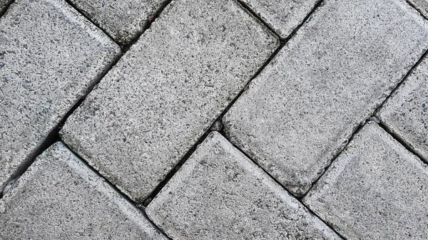 Floor motif of rectangular cement bricks for your design concept.  Geometric background pattern of rough cement floor. Paving block motif.