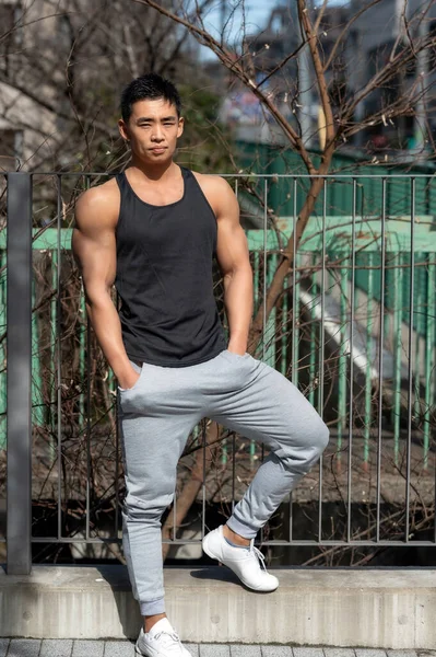 Young Japanese Asian Male Bodybuilder Wearing Tank Top Shows His — Stock Photo, Image