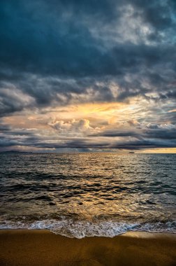 Stormy tropical skies at a beach near Pattaya, Thailand during the monsoon rainy season can produce spectacular sunsets