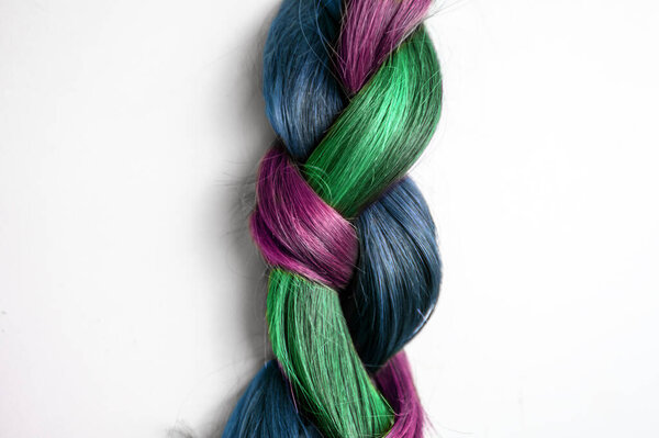 isolated colorful braid hair on white background close up .